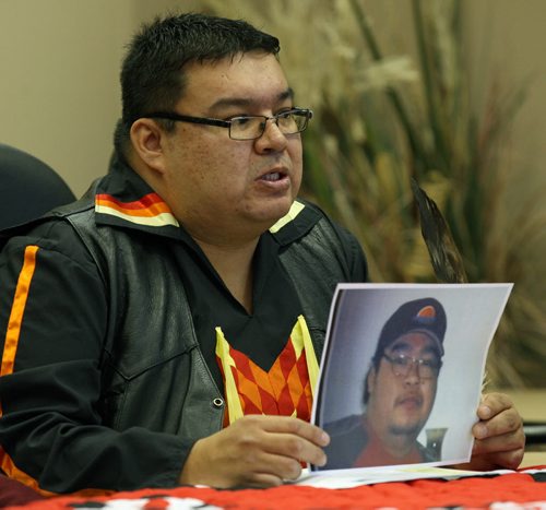 Brother Kelvin McKay holds picture of his late brother Tyson McKay at news conference- The family was talking about Tyson McKay who died of a heart attack June 25, 2015- The Cross Lake Band calling for a inquiry into poor health services on their band  See StoryDec 11, 2015   (JOE BRYKSA / WINNIPEG FREE PRESS)