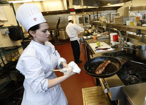 Student, Leah Walker prepares her bacon wrapped pork tenderloin while competing in the 2015 Manitoba Pork Competition. The event was held in the Red River College - Paterson GlobalFoods Institute on Friday.   Nick Martin story Wayne Glowacki / Winnipeg Free Press Dec. 11   2015