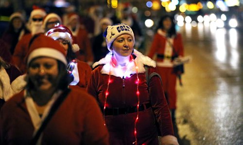 In Osborne Village, participants in SantaCon, a charity pub crawl with proceeds going to the Christmas Cheer Board, Saturday, December 12, 2015. . (TREVOR HAGAN/WINNIPEG FREE PRESS)