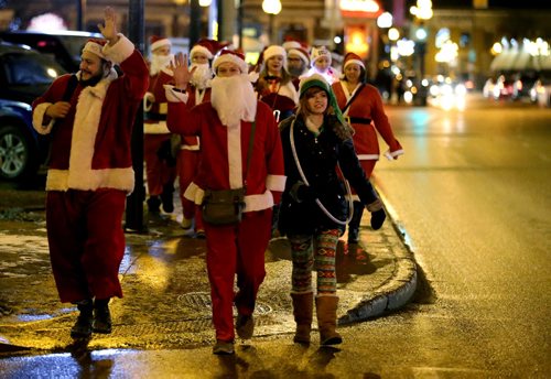 In Osborne Village, participants in SantaCon, a charity pub crawl with proceeds going to the Christmas Cheer Board, Saturday, December 12, 2015. . (TREVOR HAGAN/WINNIPEG FREE PRESS)