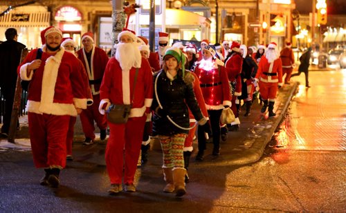 In Osborne Village, participants in SantaCon, a charity pub crawl with proceeds going to the Christmas Cheer Board, Saturday, December 12, 2015. . (TREVOR HAGAN/WINNIPEG FREE PRESS)