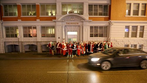 In Osborne Village, participants in SantaCon, a charity pub crawl with proceeds going to the Christmas Cheer Board, Saturday, December 12, 2015. . (TREVOR HAGAN/WINNIPEG FREE PRESS)