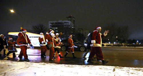 In Osborne Village, participants in SantaCon, a charity pub crawl with proceeds going to the Christmas Cheer Board, Saturday, December 12, 2015. . (TREVOR HAGAN/WINNIPEG FREE PRESS)