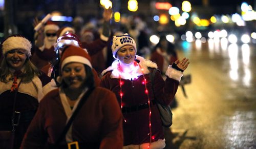 In Osborne Village, participants in SantaCon, a charity pub crawl with proceeds going to the Christmas Cheer Board, Saturday, December 12, 2015. . (TREVOR HAGAN/WINNIPEG FREE PRESS)