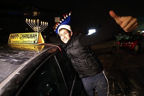 December 13, 2015 - 151213  -  JJ Duchman installs a menorah on his car in preparation for  leading a parade through River Heights and Tuxedo in celebration of the Chanukah season Sunday, December 13, 2015. John Woods / Winnipeg Free Press