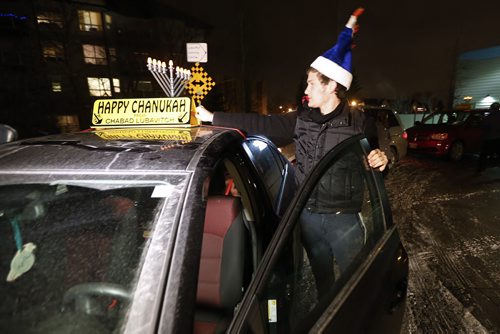 December 13, 2015 - 151213  -  JJ Duchman installs a menorah on his car in preparation for  leading a parade through River Heights and Tuxedo in celebration of the Chanukah season Sunday, December 13, 2015. John Woods / Winnipeg Free Press