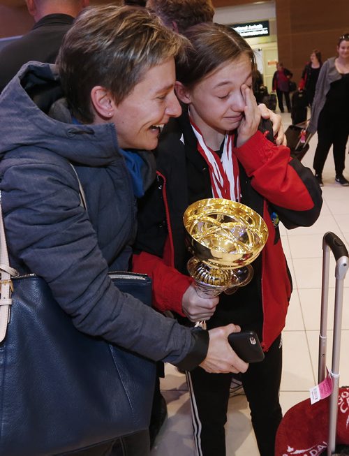 December 13, 2015 - 151213  -  Brynne Abgrall, 12, gold medalist in Modern Solo at the IDO Ballet, Jazz and Modern Championships weeps as she is greeted by her mom Kaye at the Winnipeg airport. Members of Team Canada West dance team arrived at the Winnipeg airport Sunday, December 13, 2015. Team Canada West which had 17 dancers on it took home four gold medals and one bronze in the 15th World Dance Week in Mikolajki, Poland. Competitors compete for individual and team titles in IDO Ballet, Jazz and Modern Championships. John Woods / Winnipeg Free Press