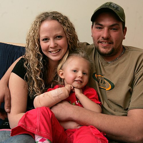 BORIS MINKEVICH / WINNIPEG FREE PRESS  080128 Kerri and Wes Olfert with their daughter Katelynn, who was all banged up in a MVC, pose for a photo at Katelynn's Uncle's place.