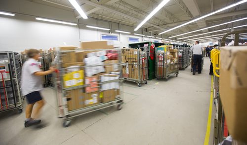 Postal workers sort letters and packages on the busiest day of the year at a sorting facility in Winnipeg on Monday, Dec. 14, 2015.  (Mikaela MacKenzie/Winnipeg Free Press)