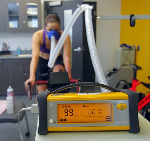 TRAINING BASKET - Daryl Hurrie high-altitude trains athlete Chantal Givens who wants to compete at an Olympic level. Photo taken at Canadian Sports Centre Manitoba at the Frank Kennedy Centre, University of Manitoba. Here athlete Chantal Givens' oxygen levels are monitored using a high tech medical device. BORIS MINKEVICH / WINNIPEG FREE PRESS DEC 14, 2015