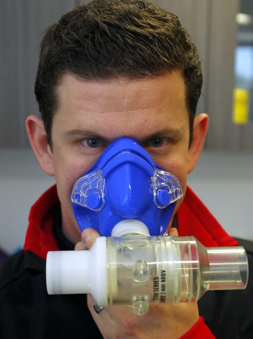 TRAINING BASKET - Daryl Hurrie high-altitude trains athlete Chantal Givens who wants to compete at an Olympic level. Photo taken at Canadian Sports Centre Manitoba at the Frank Kennedy Centre, University of Manitoba. Here Hurrie poses in the room with a face mask used in the training. BORIS MINKEVICH / WINNIPEG FREE PRESS DEC 14, 2015