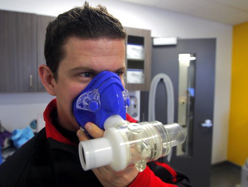 TRAINING BASKET - Daryl Hurrie high-altitude trains athlete Chantal Givens who wants to compete at an Olympic level. Photo taken at Canadian Sports Centre Manitoba at the Frank Kennedy Centre, University of Manitoba. Here Hurrie poses in the room with a face mask used in the training. BORIS MINKEVICH / WINNIPEG FREE PRESS DEC 14, 2015