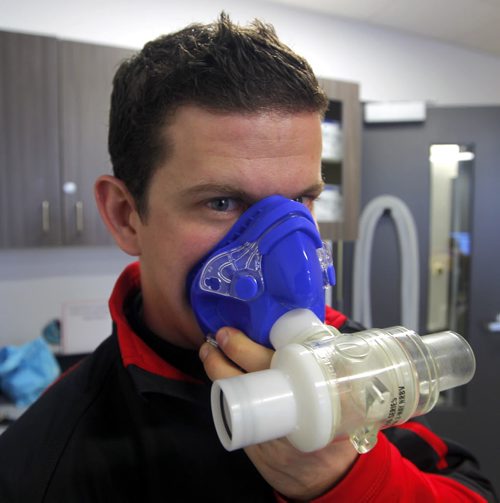 TRAINING BASKET - Daryl Hurrie high-altitude trains athlete Chantal Givens who wants to compete at an Olympic level. Photo taken at Canadian Sports Centre Manitoba at the Frank Kennedy Centre, University of Manitoba. Here Hurrie poses in the room with a face mask used in the training. BORIS MINKEVICH / WINNIPEG FREE PRESS DEC 14, 2015