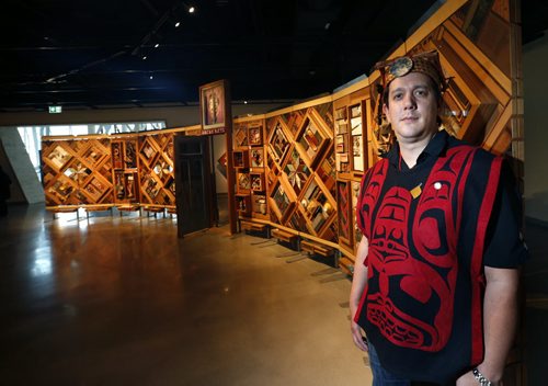 Artist Carey Newman of Vancouver Island with his art installation called  The Witness Blanket at the opening Monday in the Canadian Museum For Human Rights.The exhibit was created from hundreds of items reclaimed from residential schools, churches, government buildings, and other structures all across Canada. Intern story Wayne Glowacki / Winnipeg Free Press Dec. 14   2015