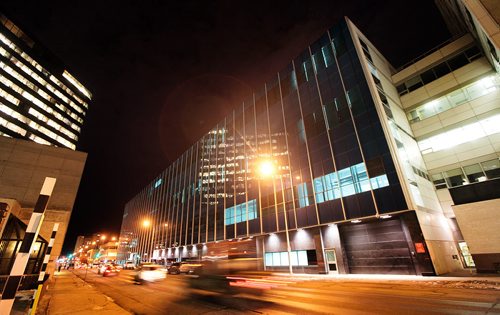 Evening traffic swirls past the new City Poilce HQ building along Gary Street Monday. See story. December 14, 2015 - (Phil Hossack / Winnipeg Free Press)