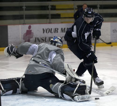 Manitoba Moose goaltender Eric Comrie makes a save on Jiri Fronk during practice at MTS Iceplex Tuesday - see storyDec 15, 2015   (JOE BRYKSA / WINNIPEG FREE PRESS)