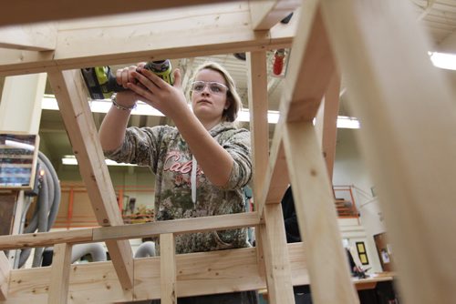 Grade 11 Nelson McIntyre Collegiate student Taryn Hill uses safety measures by SAFE Work Manitoba while working in the woodworking shop on projects Tuesday morning.   A press conference was held by SAFE work Manitoba announcing new strategy to address  injuries to young workers  each year in the Province in one of the shop classes in the school.   Dec 15, 2015 Ruth Bonneville / Winnipeg Free Press