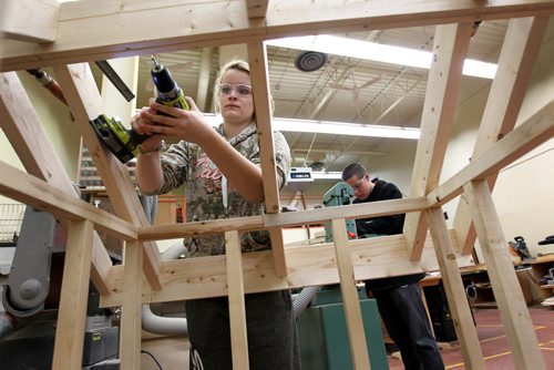 Grade 11 Nelson McIntyre Collegiate student Taryn Hill uses safety measures by SAFE Work Manitoba while working in the woodworking shop on projects Tuesday morning.   A press conference was held by SAFE work Manitoba announcing new strategy to address  injuries to young workers  each year in the Province in one of the shop classes in the school.   Dec 15, 2015 Ruth Bonneville / Winnipeg Free Press