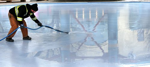 Elvis Johnson carefully floods the skating rink under the canopy at The Forks Tuesday afternoon. The flooding began Tuesday and they hope to have the ice in shape for skating by Christmas Eve. Wayne Glowacki / Winnipeg Free Press Dec. 15   2015