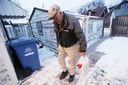 December 15, 2015 - 151215  -  Rodney Pearson, 76, walks from his garage with groceries on Redwood Avenue Tuesday, December 15, 2015. Pearson and his wife Doris, who have been married for 53 years, have lived in the house for 45 years and recently received a Winnipeg Neigbourhood Liveability Bylaw Order from the city to paint the outside of their home by this spring or face a $1000 fine and jail time. John Woods / Winnipeg Free Press