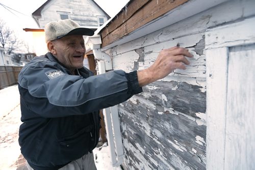 December 15, 2015 - 151215  -  Rodney Pearson, 76, checks the condition of his exterior house paint on Redwood Avenue Tuesday, December 15, 2015. Pearson and his wife Doris, who have been married for 53 years, have lived in the house for 45 years and recently received a Winnipeg Neigbourhood Liveability Bylaw Order from the city to paint the outside of their home by this spring or face a $1000 fine and jail time. John Woods / Winnipeg Free Press