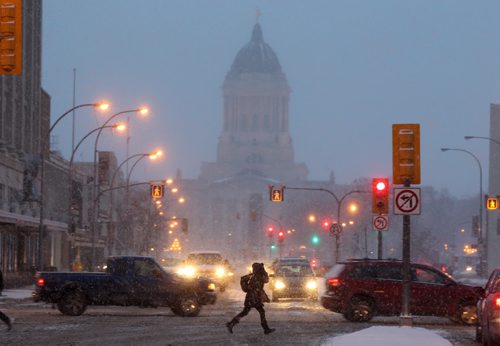 A Pedestrian scrambles down Memorial Blvd in Winnipeg as Wednesdays snow storm sets lowering visibility in the city - Standup PhotoDec 16, 2015   (JOE BRYKSA / WINNIPEG FREE PRESS)