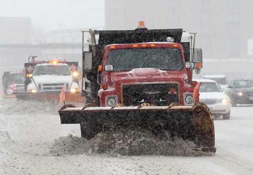 Snow plows work hard to keep West Portage Ave near Moray St free of snow during storm Wednesday near 1115PM - Standup PhotoDec 16, 2015   (JOE BRYKSA / WINNIPEG FREE PRESS)
