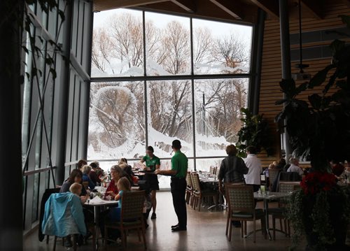 Patrons inside the Park Café in the Qualico Family Centre in Assiniboine Park get a beautiful view of the heavy snow falling in the park through many windows in the facility - Standup PhotoDec 16, 2015   (JOE BRYKSA / WINNIPEG FREE PRESS)
