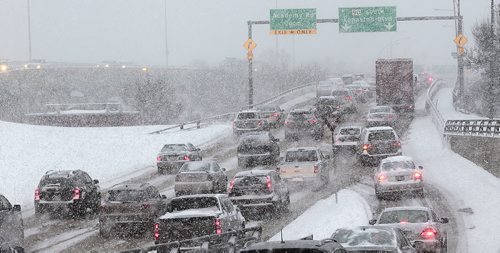 Evening Rush hour merges into a snowy frustrating drive home for commuters crossing the St James Bridge Wednesday afternoon. December 16, 2015 - (Phil Hossack / Winnipeg Free Press)