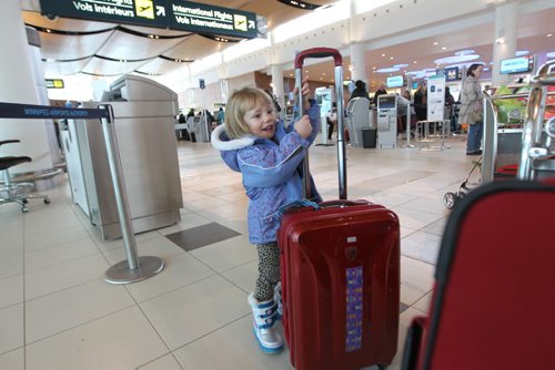 Generic photos of Winnipeg James Armstrong Richardson International Airport for story on airport fees added to your airline ticket ($25) to cover airport fees. Three-yeaer-old  Geneviève Coueslan stands next to her families bags just before checking in for a flight Wednesday afternoon.   See story.  Dec 16, 2015 Ruth Bonneville / Winnipeg Free Press