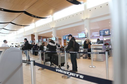 Generic photos of Winnipeg James Armstrong Richardson International Airport for story on airport fees added to your airline ticket ($25) to cover airport fees. People wait in WestJet lines to checkin Wednesday.  See story.  Dec 16, 2015 Ruth Bonneville / Winnipeg Free Press