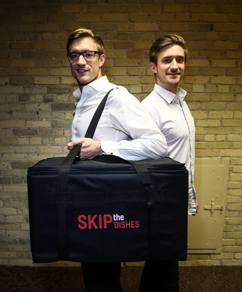 Chris Simair (right) and his brother Joshua (left) co-founders of Skip the Dishes have begun the move into their new offices on Market Avenue. The meal delivery business which is in many cities in Canada and the U.S. plans to expand from its 220 employees to around 550. 151216 - Wednesday, December 16, 2015 -  MIKE DEAL / WINNIPEG FREE PRESS