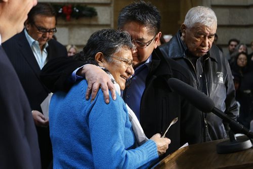 Chief Erwin Redsky, Shoal Lake No.40 First Nation and elder Lillian Henry embrace during an announcement at the Manitoba Legislature in Winnipeg, Thursday, December 17, 2015.  Manitoba Premier Greg Selinger, Carolyn Bennett, Minister of Indigenous and Northern Affairs, City of Winnipeg mayor Brian Bowman, and Chief Erwin Redsky, Shoal Lake No.40 First Nation, announced an intergovernmental partnership that will benefit the First Nation by building a 24 km road from the community to the Trans Canada Highway.   THE CANADIAN PRESS/John Woods