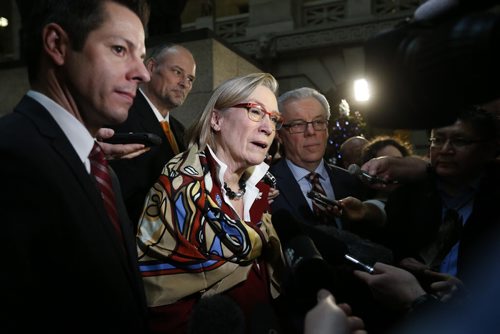At the Manitoba Legislature in Winnipeg today, Thursday, December 17, 2015 Carolyn Bennett (C), Minister of Indigenous and Northern Affairs speaks to media as Winnipeg mayor Brian Bowman (L), Manitoba Premier Greg Selinger (R) and minister Drew Caldwell (back) listen in after announcing an intergovernmental partnership that will benefit the First Nation by building a 24 km road from the community to the Trans Canada Highway.   THE CANADIAN PRESS/John Woods