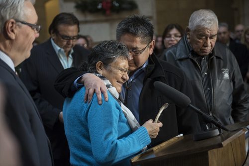 DAVID LIPNOWSKI / WINNIPEG FREE PRESS 151217  Chief Erwin Redsky, Shoal Lake 40 First Nation Elder Lilian Henry and Chief Erwin Redsky of Shoal Lake 40 First Nation embrace during a joint funding announcment between the Provincial and Federal governments for Freedom Road to Shoal Lake at the Manitoba Legislature Thursday December 17, 2015.