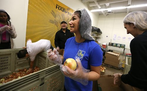 Adele Frenette has a laugh while sorting onions as employees from the RBC Advice Centre volunteered at Winnipeg Harvest at Winnipeg Harvest on Dec. 17, 2015. Photo by Jason Halstead/Winnipeg Free Press RE: Social Page for Dec. 19, 2015