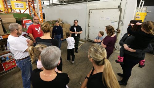 Winnipeg Harvest staff member Susan Stryk (centre, top) gives directions to volunteers at as part of Family Night at the food bank on Dec. 17, 2015. Photo by Jason Halstead/Winnipeg Free Press RE: Social Page for Dec. 19, 2015