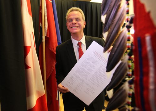 Minister of Education, James Allum is all smiles as he holds one of 3 fully signed Indigenous Education Blueprints at a formal event Friday  held at the U of M's Migizii Agamik  Bald Eagle Lodge. See Nick Martin story.  Dec 18, 2015 Ruth Bonneville / Winnipeg Free Press