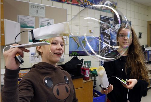 Ecole Stonewall Centennial School Space Club members Tessa Lawrence, left, and Trinity Rutledge use Little Bits bubblebots (robotic controlled fans) they built to blow bubbles and move them through the air Friday in their classroom  to showcase  to the media the technological skills the students have learnt. The event was in honour of the release of the new Star Wars: The Force Awakens movie. In the afternoon the class had the opportunity to watch  The Star Wars: Episode VI Return of the Jedi. Wayne Glowacki / Winnipeg Free Press Dec. 18  2015