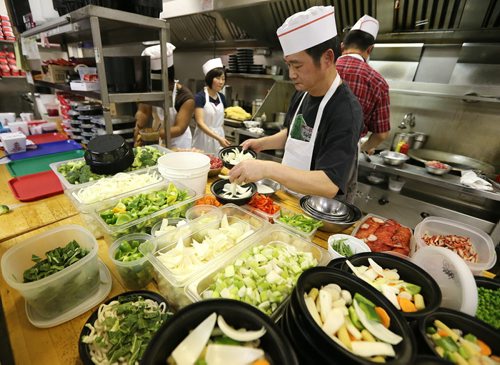 The busy kitchen at 4 Seasons Chinese Food at Southdale Centre on Dec. 18, 2015. The Chinese take-out and delivery restaurant has been in operation for almost 30 years and is extremely busy this time of year. Customers usually start placing their orders for Christmas and New Years Eve in August or September. Photo by Jason Halstead/Winnipeg Free Press RE: Dave Sanderson story