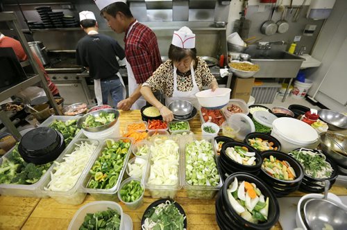 The busy kitchen at 4 Seasons Chinese Food at Southdale Centre on Dec. 18, 2015. The Chinese take-out and delivery restaurant has been in operation for almost 30 years and is extremely busy this time of year. Customers usually start placing their orders for Christmas and New Years Eve in August or September. Photo by Jason Halstead/Winnipeg Free Press RE: Dave Sanderson story