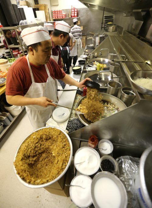 Wok cooks work at 4 Seasons Chinese Food at Southdale Centre on Dec. 18, 2015. The Chinese take-out and delivery restaurant has been in operation for almost 30 years and is extremely busy this time of year. Customers usually start placing their orders for Christmas and New Years Eve in August or September. Photo by Jason Halstead/Winnipeg Free Press RE: Dave Sanderson story