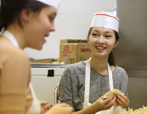 Skye Rickner (right) and co-worker Breanne Fedevich make wontons at 4 Seasons Chinese Food at Southdale Centre on Dec. 18, 2015. The Chinese take-out and delivery restaurant has been in operation for almost 30 years and is extremely busy this time of year. Customers usually start placing their orders for Christmas and New Years Eve in August or September. Photo by Jason Halstead/Winnipeg Free Press RE: Dave Sanderson story