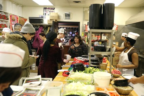 Owner Cathy Rickner (middle, rear) checks on the busy kitchen at 4 Seasons Chinese Food at Southdale Centre on Dec. 18, 2015. The Chinese take-out and delivery restaurant has been in operation for almost 30 years and is extremely busy this time of year. Customers usually start placing their orders for Christmas and New Years Eve in August or September. Photo by Jason Halstead/Winnipeg Free Press RE: Dave Sanderson story