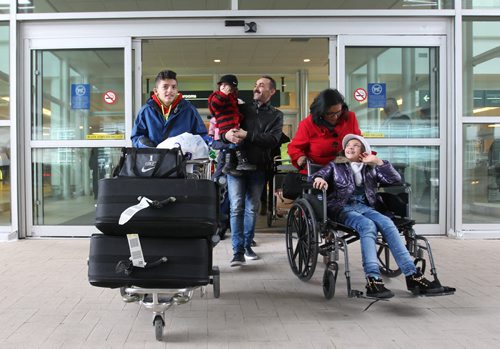 The Albakar family of eight from Syria make their way outside the airport in Winnipeg after arriving Saturday headed to their sponsors, The Welcome Place See MA story.  Dec 19, 2015 Ruth Bonneville / Winnipeg Free Press