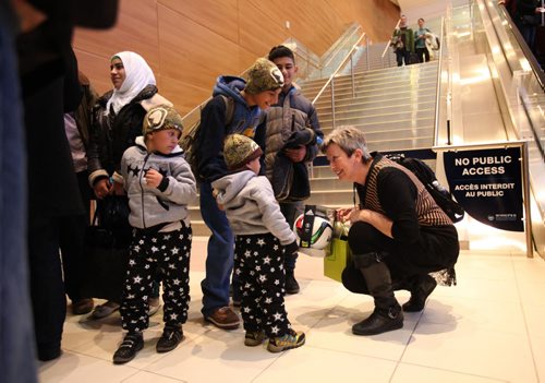 The younger children in the Daas family from Syria are presented gifts and toys from sponsors after they arrive at the airport in Wpg. Saturday.  See MA story.  Dec 19, 2015 Ruth Bonneville / Winnipeg Free Press