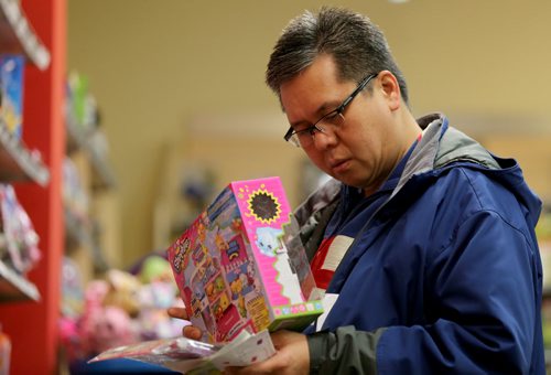Noel Santo Domingo shopping for Shopkins for his 9 year old daughter inside the Showcase Store at Polo Park, Sunday, December 20, 2015. (TREVOR HAGAN/WINNIPEG FREE PRESS)