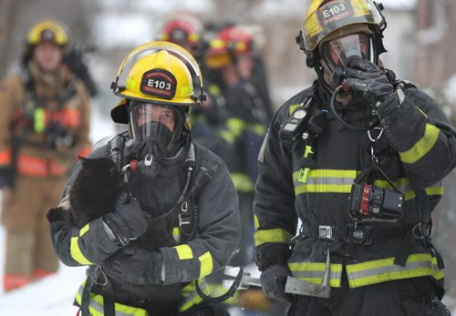 A firefighter rescued Oreo the cat from a apartment fire at 686 Toronto Ave Monday morningPolice have closed Toronto from Sargent Ave to Wellington-Breaking News-Dec 21, 2015 (JOE BRYKSA / WINNIPEG FREE PRESS)