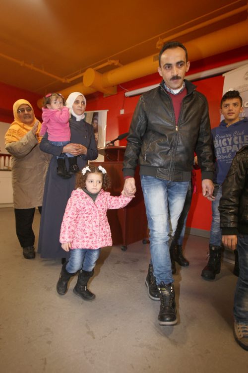 Former Syrian refuges the Albakar family enter a official welcome ceremony at Welcome House 521 Bannatyne Ave  Other dignitaries not pictured in attendance Premier Greg Selinger, and Jim Carr Minister of Natural Recourses, Government of Canada, and mayor Brian Bowman-See Carol Sanders storyDec 17, 2015 (JOE BRYKSA / WINNIPEG FREE PRESS)

In photo - Father Yaser Albakar (in leather jacket) with daughter Hadil, 2, and mother Raghdaa, holding Sham, 10 months