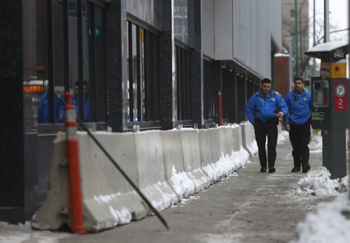 Winnipeg Police Cadets walk past the concrete security dividers by the the new police HQ along along Smith St. Monday. Bart Kives story. Wayne Glowacki / Winnipeg Free Press Dec. 21  2015
